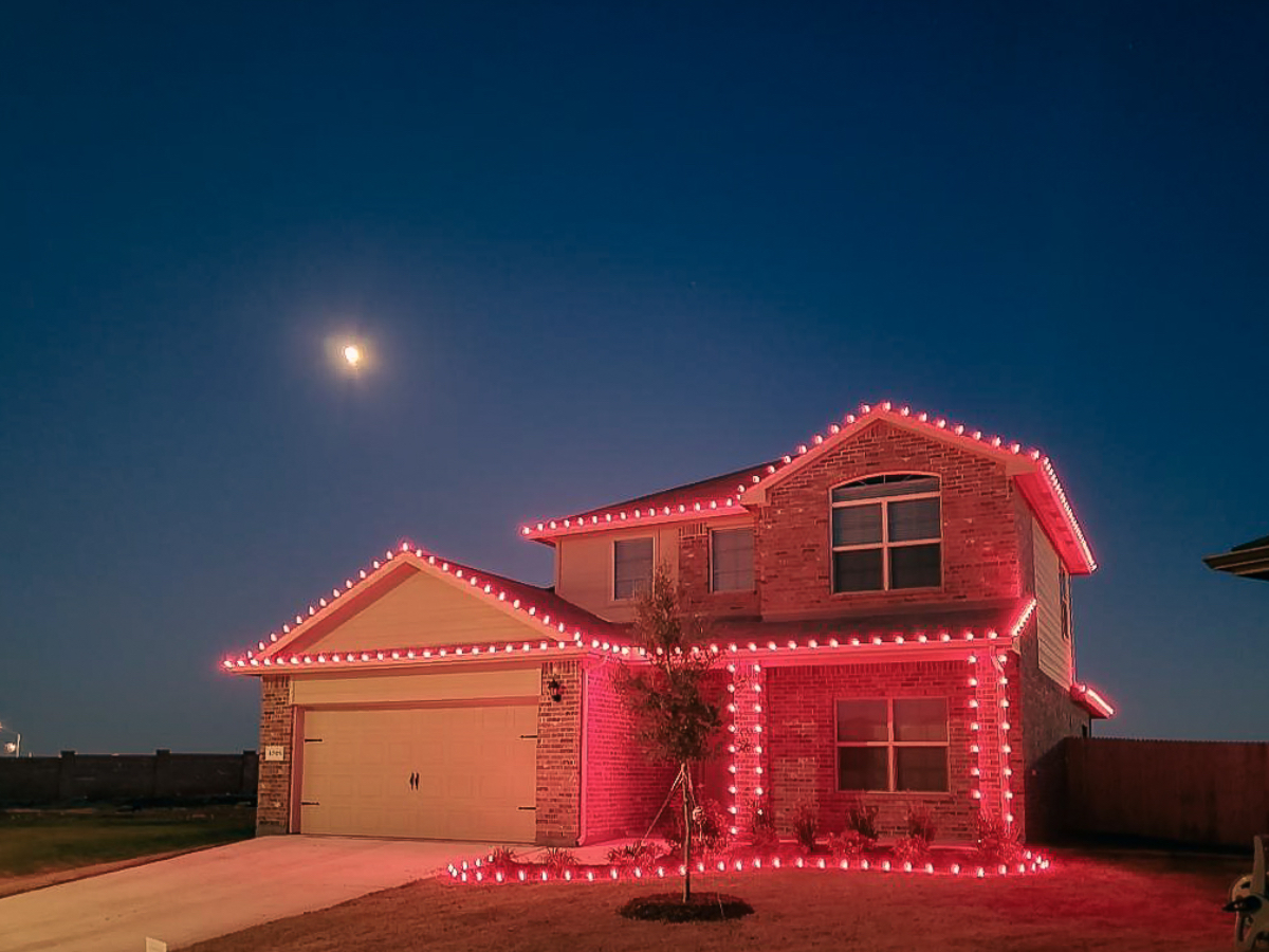 Roofline Christmas lights on two-story brick home in Fort Worth
